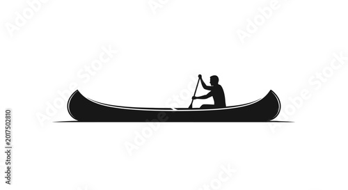 Man paddling a canoe on water.