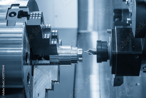High-precision hole guide drilling using a center drill tool on a metal shaft part with a CNC lathe machine.