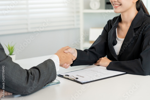 Foto Executives accept job application and shake hand, documents and job applicants resume to match the position