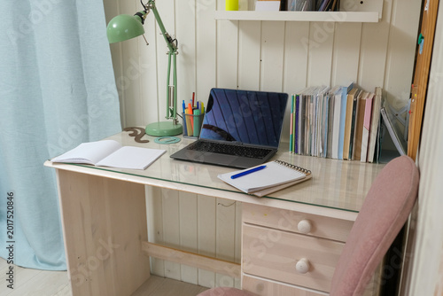 Orderly workspace setup. Organized desk, work from home concept. Remote office station with laptop display, keyboard, paperwork. Work place for distance working. Tidy table with monitor and printer