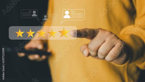 Close up young man and hold smartphone and point review online service and experience with good feedback and ranking score from customer for business quality and evaluation concept