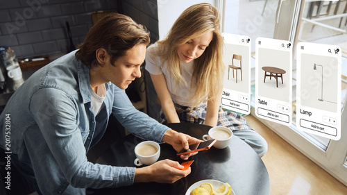 Foto Couple shopping for furniture online with floating ecommerce displays at home