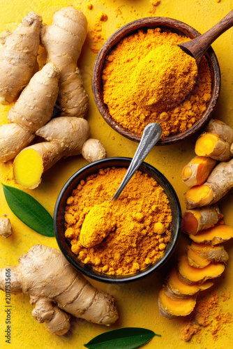 Vibrant Turmeric Still Life Roots Powder and Bowls on Yellow.