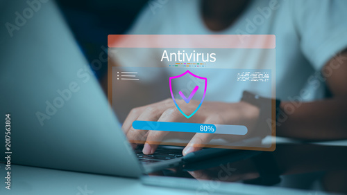 Photos User using laptop for antivirus software scanning with digital shield and loading bar on virtual screen