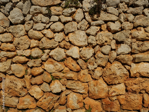 Bild auf Leinwand Porous mares dry stone wall with irregular structure and warm natural colors