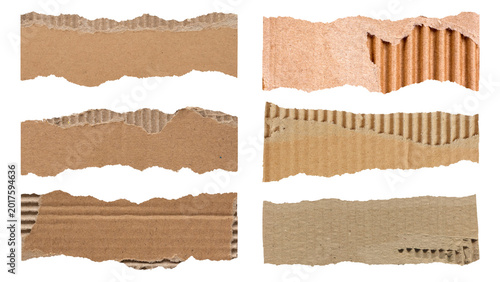 Obraz na płótnie Torn corrugated cardboard paper strips with rough ripped edges isolated on black