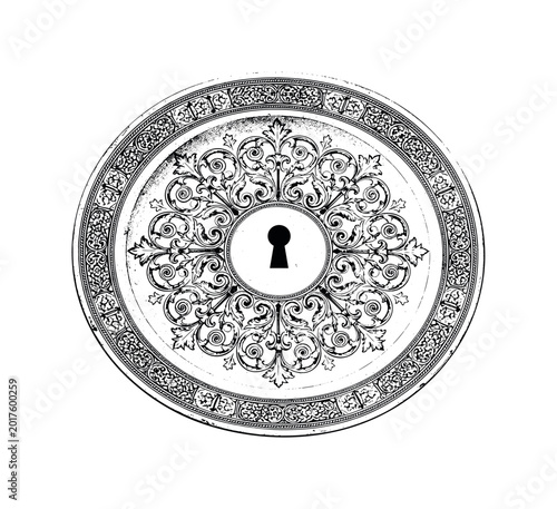 Antique ornamental plate with intricate scrollwork and a central keyhole motif