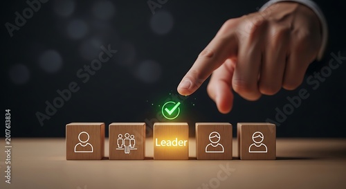Hand selecting leader icon on wooden blocks