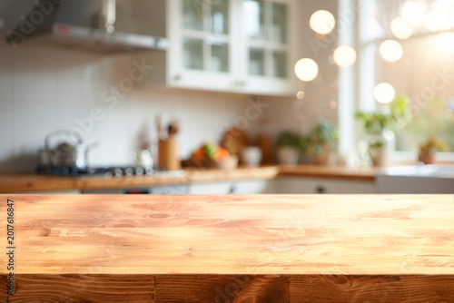 Konstfotografi A cozy kitchen flooded with morning light and a natural wood countertop in the f