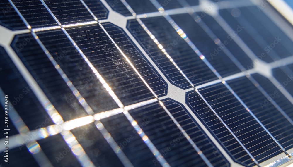 Fototapeta premium Showing close-up photovoltaic cells reflecting sunlight on rooftop, with silver busbars