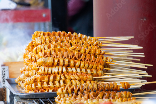 Many pilled up skewed calmas as appetizer snack in the street market