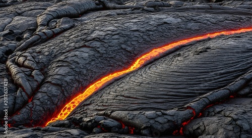 Flowing Molten Lava in a Volcanic Landscape - A Fiery Orange Stream Against Dark Rock