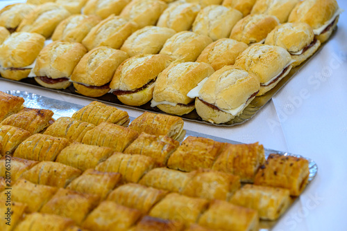 Assorted pastries and sandwiches on catering tray