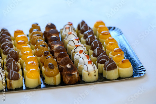 Assorted chocolate and glazed mini pastries on serving tray