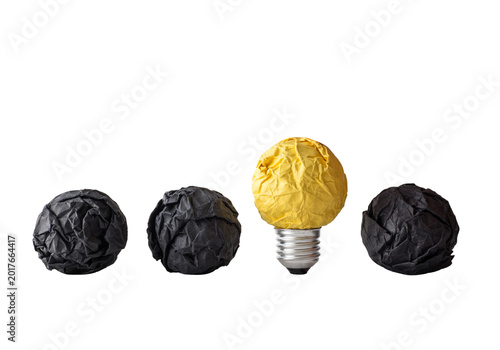 Fotografía Three black paper balls with one yellow light bulb, standout idea concept isolat