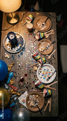 Empty birthday plates and decorations on table after party  