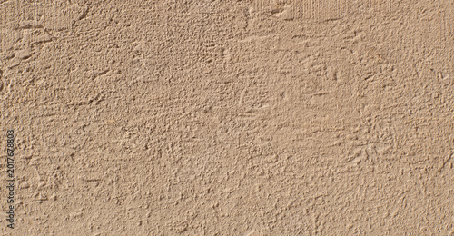 Beige stucco wall texture with rough plaster background