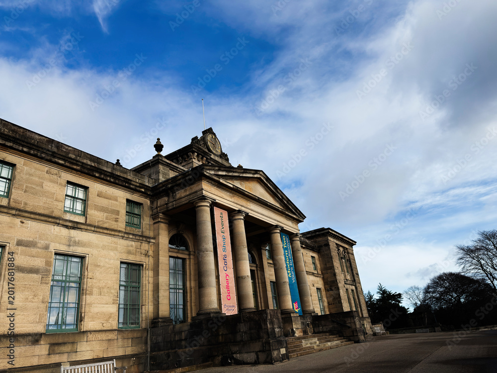 Fototapeta premium Historic stone Modern Two Dean Gallery building with classical columns and clock in Edinburgh, Scotland, UK under a dramatic sky