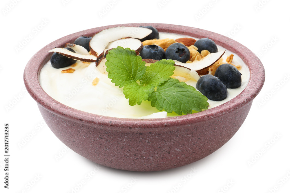 Fototapeta premium Tasty yogurt with coconut, blueberries, nuts, oatmeal and melissa isolated on white