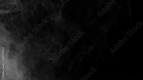 Realistic white smoke cloud billowing slowly across a dark black background.