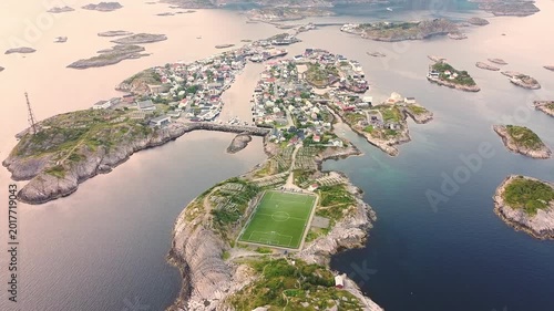 Aerial reveal of Henningsvær fishing village from famous football field, Lofoten Islands Norway drone cinematic view