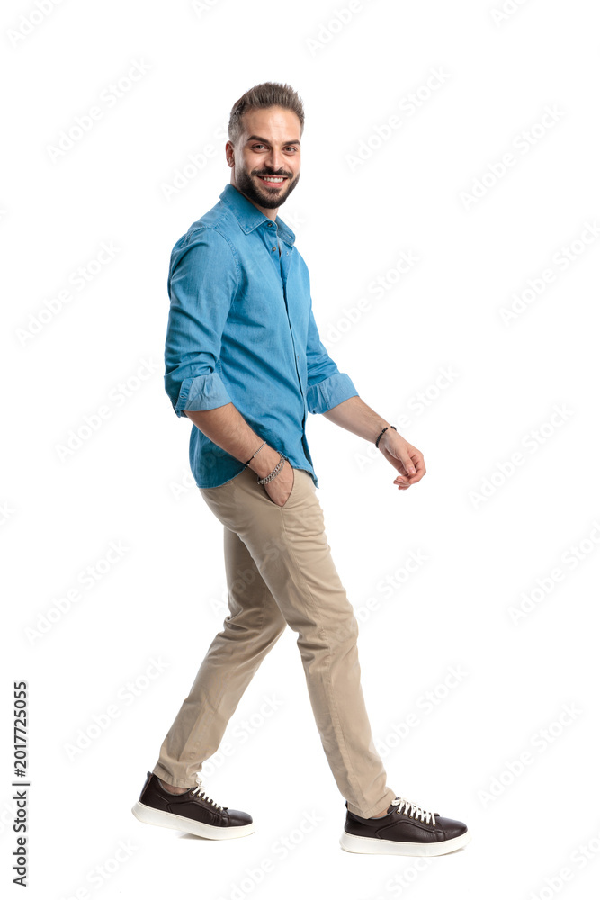 Naklejka premium Side view of happy casual man walking