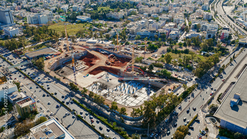 Obraz na płótnie Construction site with multiple cranes and ongoing foundation work showing urban