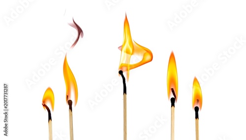 Several matches are burning, with orange and yellow flames against a stark white backdrop, displaying varied combustion states
