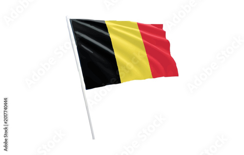 Belgian flag waving on a white pole with black yellow and red stripes on a plain background