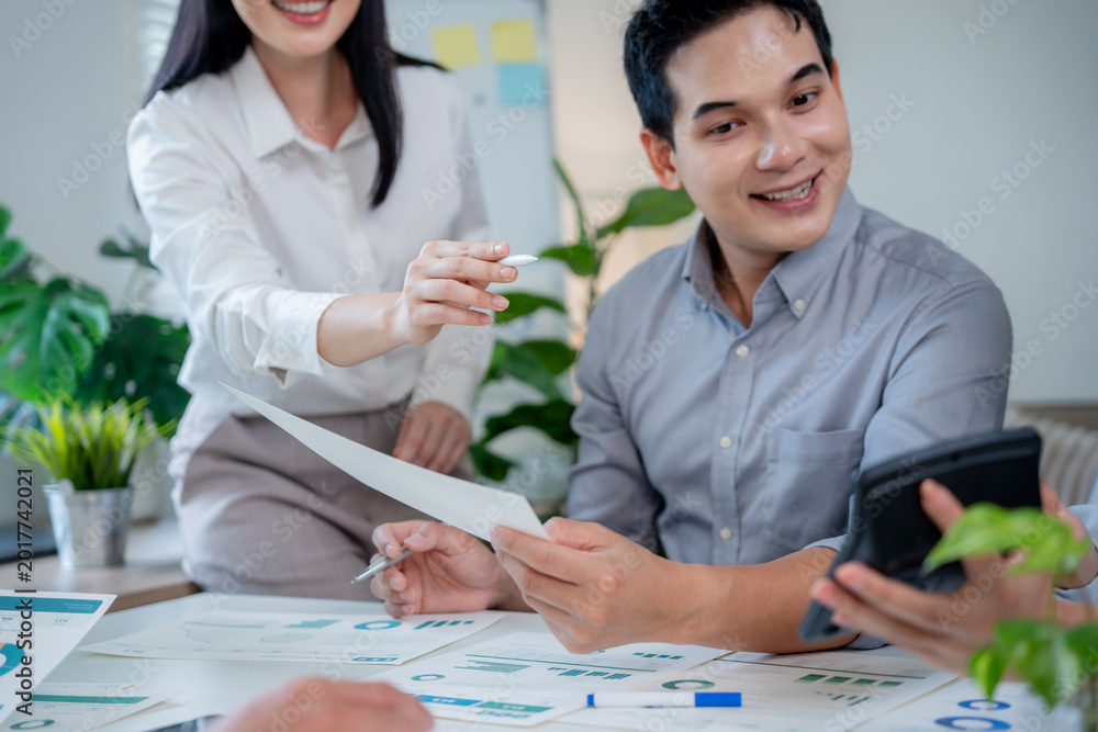 Fototapeta premium Diverse business professionals working together in a modern office, analyzing data and discussing financial strategies