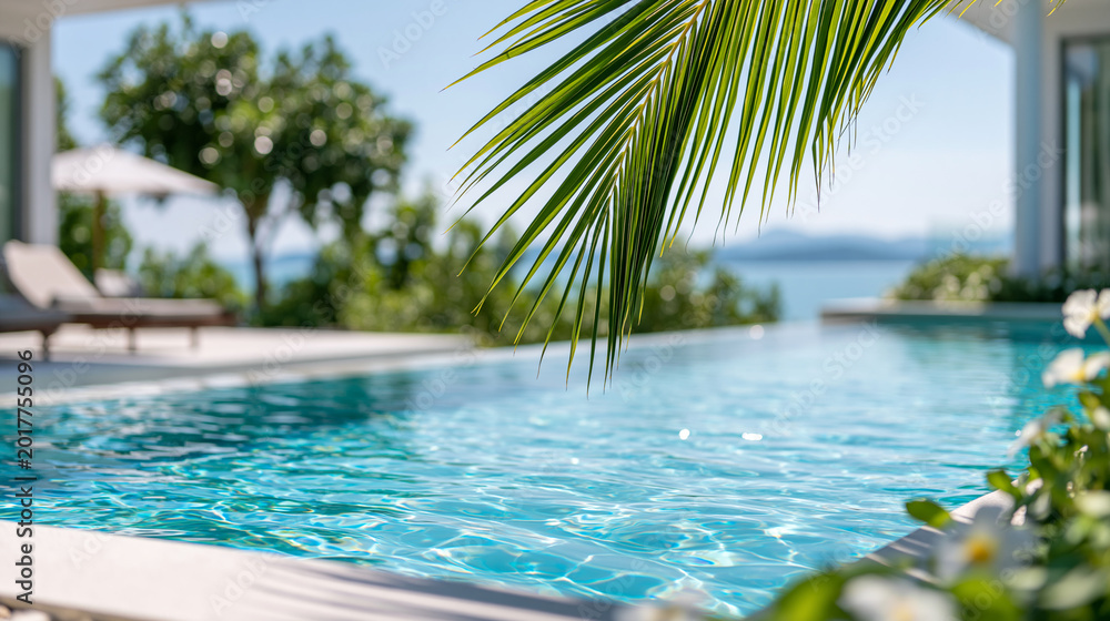 Obraz premium Close-up of a relaxing oceanfront villa pool with tropical views and sunlight on water, villa relaxation concept, tropical pool view photography, ocean-facing luxury resort,
