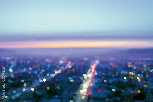 Soft focus aerial view of city lights at dusk with a pastel sky