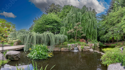 Nantes, France - 05 07 2026: Versailles Island garden. Panoramic view of water feature reflecting the Japanese garden in spring