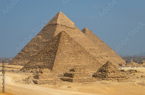 The three pyramids of Giza rising above the desert near Cairo, Egypt. Iconic ancient Egyptian monuments, UNESCO World Heritage site and symbol of ancient civilization and history