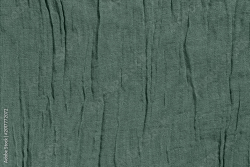 Olive green wrinkled fabric texture with soft vertical folds and woven textile surface, natural cotton cloth background for fashion mockups, military style design and rustic branding