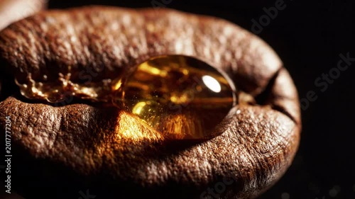 Macro closeup of a single roasted coffee bean with a drop of liquid falling onto its surface, dark moody lighting, beverage industry concept