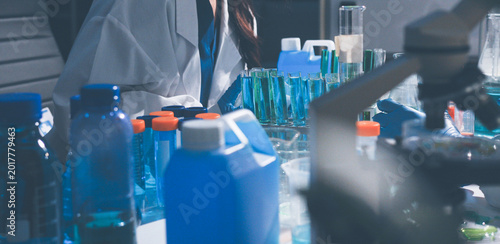 Science, laboratory and woman with pipette, test tube and biotech solution in research. Medical innovation, scientist or lab technician in study for healthcare, medicine and vaccine results feedback.