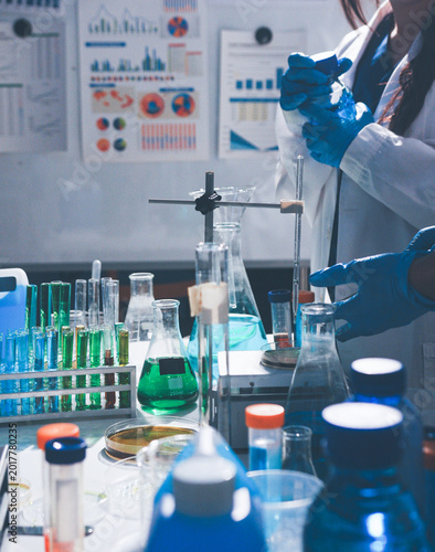 Science, laboratory and woman with pipette, test tube and biotech solution in research. Medical innovation, scientist or lab technician in study for healthcare, medicine and vaccine results feedback.