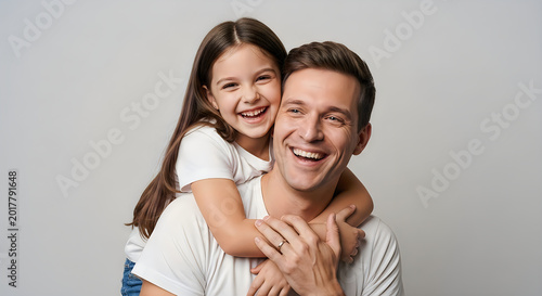Father and daughter laughing together in bright natural light