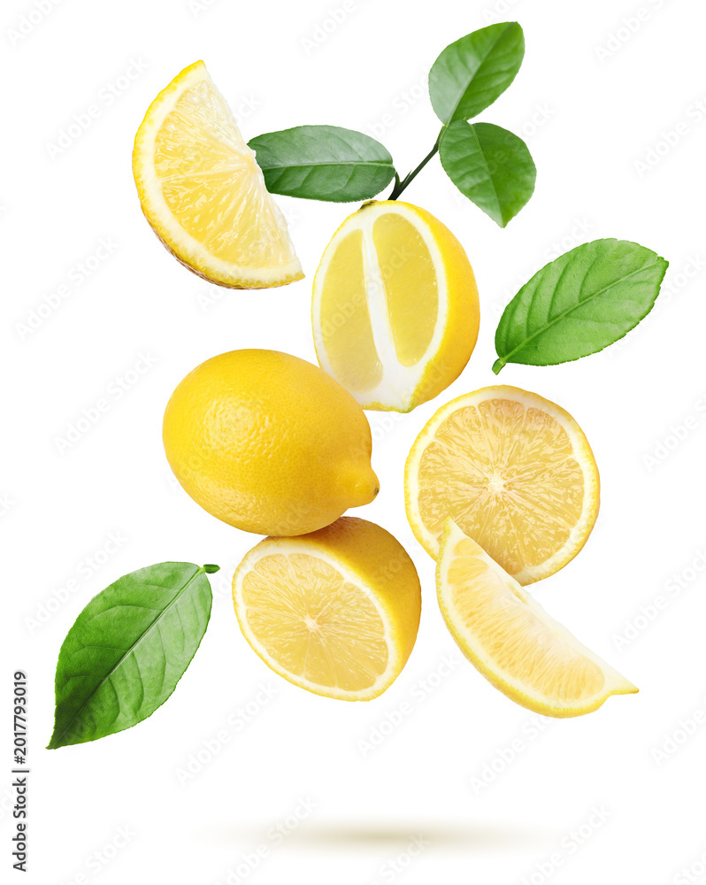 Obraz premium Juicy lemons and green leaves falling on transparent background. Citrus fruit