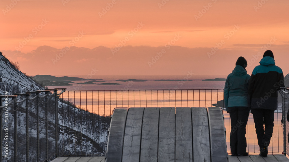 Fototapeta premium Couple Enjoys Sunset View Over Snowy Landscape in Norway