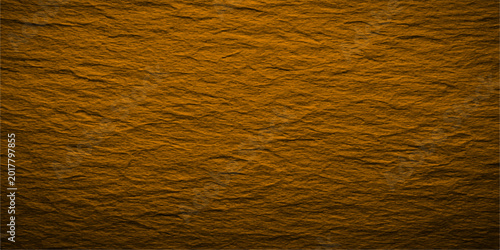 Foto Textured surface, showing the intricate details of a layered, rough stone in the golden glow