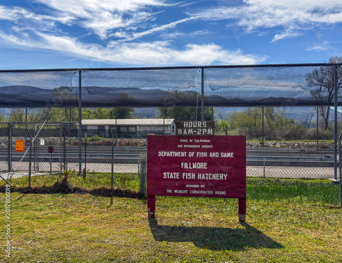 Filmore, California, USA - February 25, 2026: Sign in front of the water channels under blue cloudscape at Filmore State Fish Hatchery