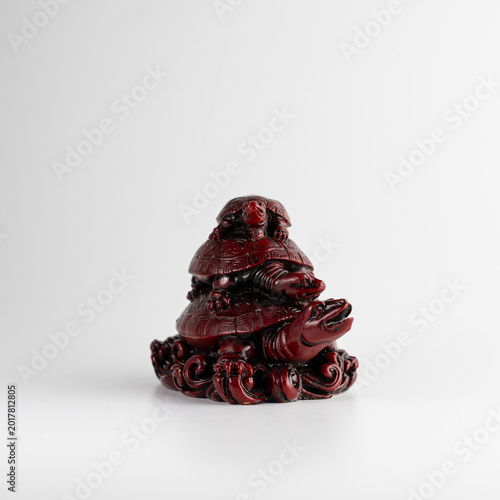 Decorative red turtle sculpture isolated on white background vertical minimal art object