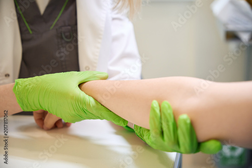 Healthcare professional examining young patient in medical room