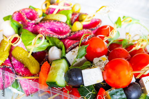 Closeup of gourmet appetizer skewers with cherry tomatoes cheese olives and salami
