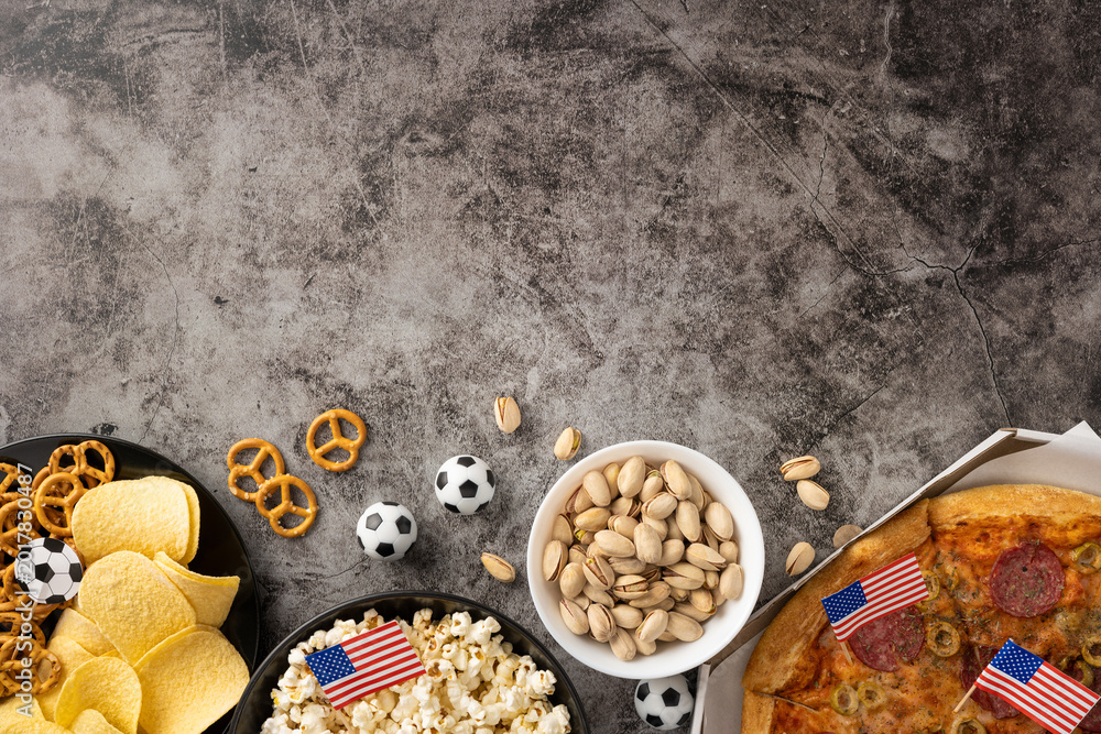 Fototapeta premium Football championship snacks spread with pizza, popcorn, pistachio, chips and pretzels for game day