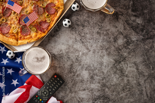 Konstfotografi Football championship viewing with pizza, beer, American flag and TV remote