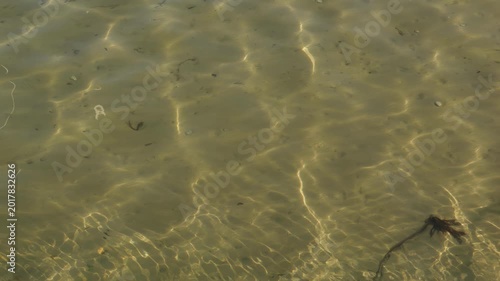 Shallow rippling clear sea water over sand slow motion stock footage
