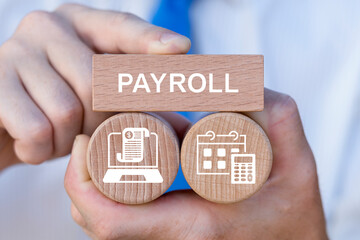 Concept of payroll. Business person holding wooden blocks with icons sees the text PAYROLL. Salary payroll system management.